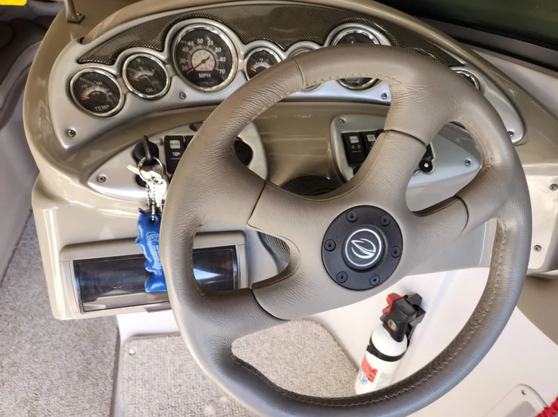 Slide: The Image of 2006 Crownline 230 LS boat dashboard with steering wheel and gauges. - 7