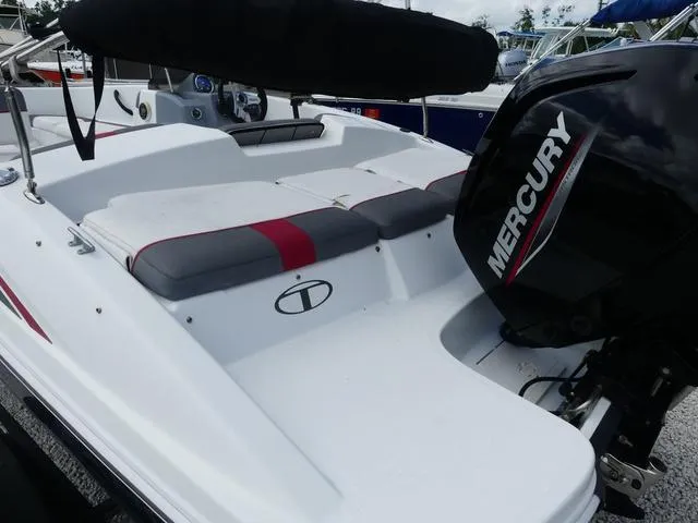 Slide: The Image of 2021 Tahoe T16 boat with Mercury engine, featuring white and red seating. - 12