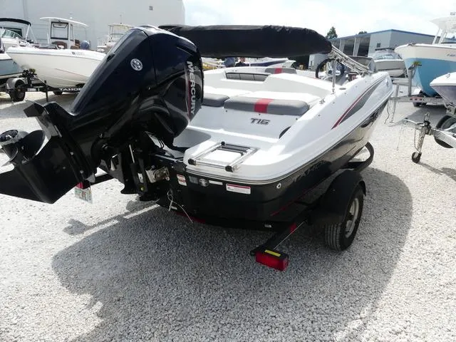 Slide: The Image of 2021 Tahoe T16 boat with Mercury outboard motor on a trailer in a marina. - 5