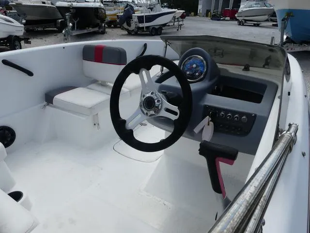 Slide: The Image of 2021 Tahoe T16 boat interior with steering wheel and dashboard controls. - 6