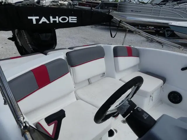 Slide: The Image of 2021 Tahoe T16 boat interior with white and gray seating, steering wheel, and visible branding. - 7
