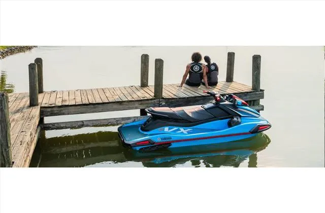 Slide: The Image of 2024 Yamaha WaveRunner VX docked by a wooden pier with two people sitting nearby. - 13