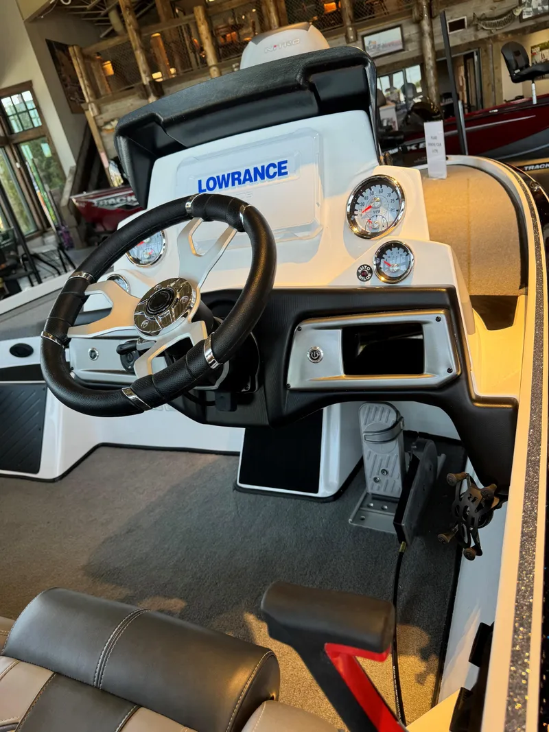 Slide: The Image of 2024 Nitro Z19 Pro boat dashboard with steering wheel and gauges. - 2
