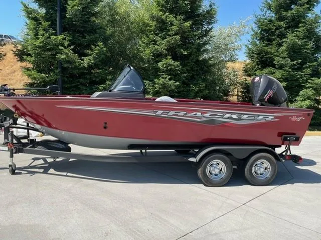 The Image of 2024 Tracker Targa V-19 WT boat on trailer, parked outdoors with trees in background. - 0