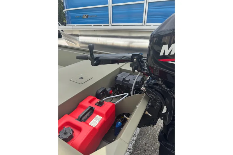 Slide: The Image of 2024 Tracker Grizzly 1648 Jon boat with motor and red fuel tank. - 2