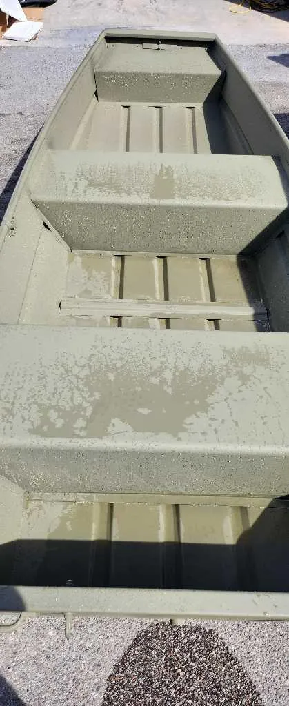 Slide: The Image of 2024 Tracker Grizzly 1436 Jon boat, interior view showing seating and floor. - 2