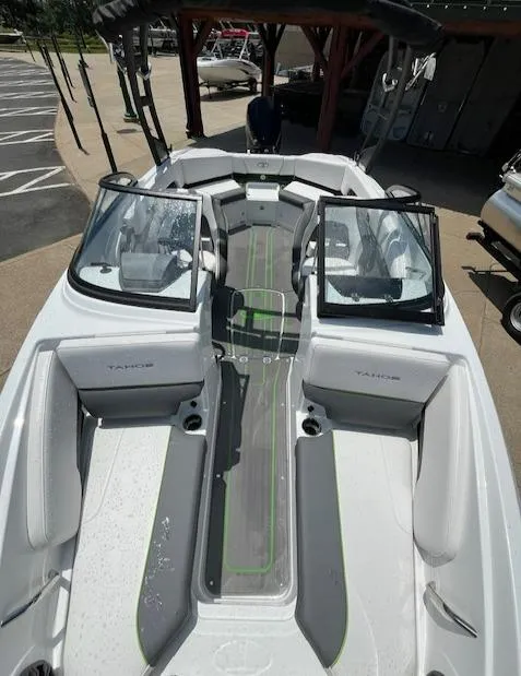 Slide: The Image of 2024 Tahoe 210 S boat with open cockpit and seating area. - 2