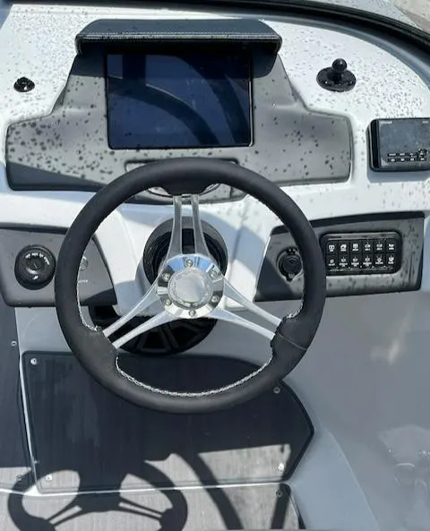 Slide: The Image of Steering console of 2024 Tahoe 210 S boat with modern controls and touchscreen display. - 4