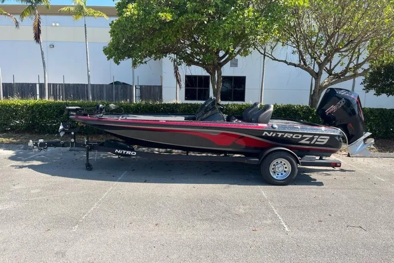 The Image of 2024 Nitro Z19 boat parked outdoors, featuring sleek design and modern engine. - 0