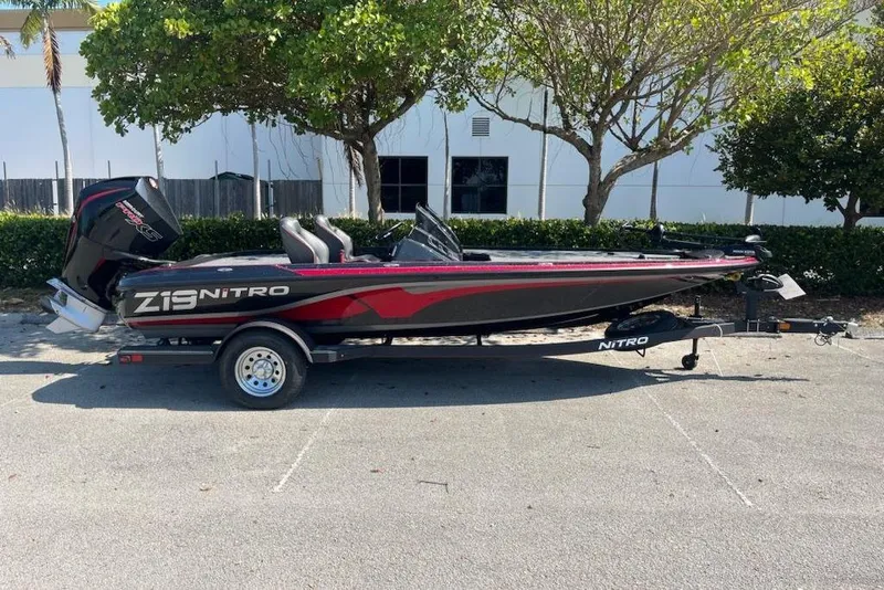 Slide: The Image of 2024 Nitro Z19 boat parked outdoors, featuring sleek design and modern features. - 1