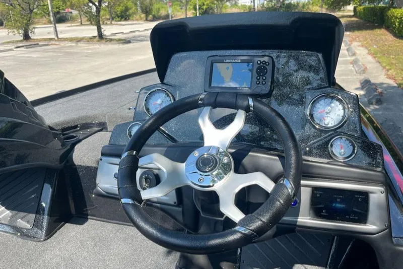 Slide: The Image of 2024 Nitro Z19 boat dashboard with steering wheel, gauges, and navigation system. - 3