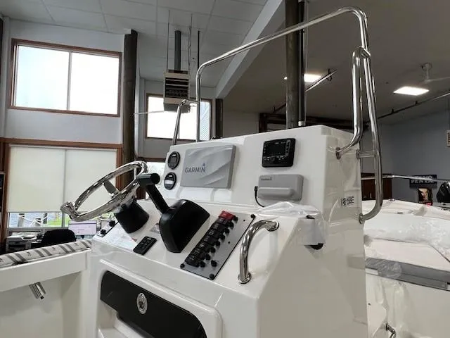 Slide: The Image of 2024 Parker 18SE Center Console boat interior with steering wheel and control panel. - 2