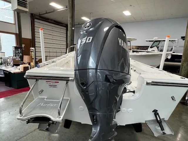 Slide: The Image of 2024 Parker 18SE Center Console boat with Yamaha 150 outboard motor in showroom. - 4