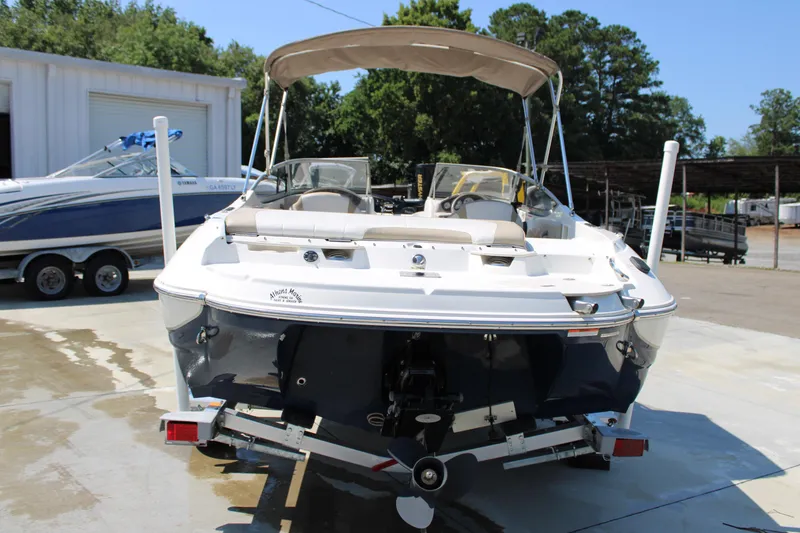 Slide: The Image of 2014 Stingray 198 LF boat on trailer, parked outdoors with canopy. - 13