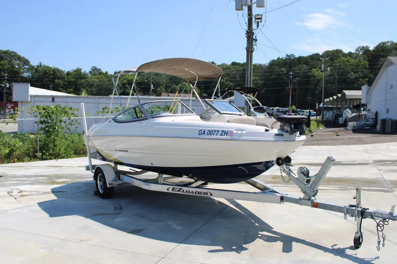 Slide: The Image of 2014 Stingray 198 LF boat on trailer with canopy in sunny outdoor setting. - 15