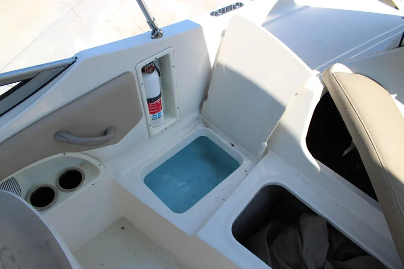 Slide: The Image of 2014 Stingray 198 LF boat interior with storage compartments and fire extinguisher. - 18