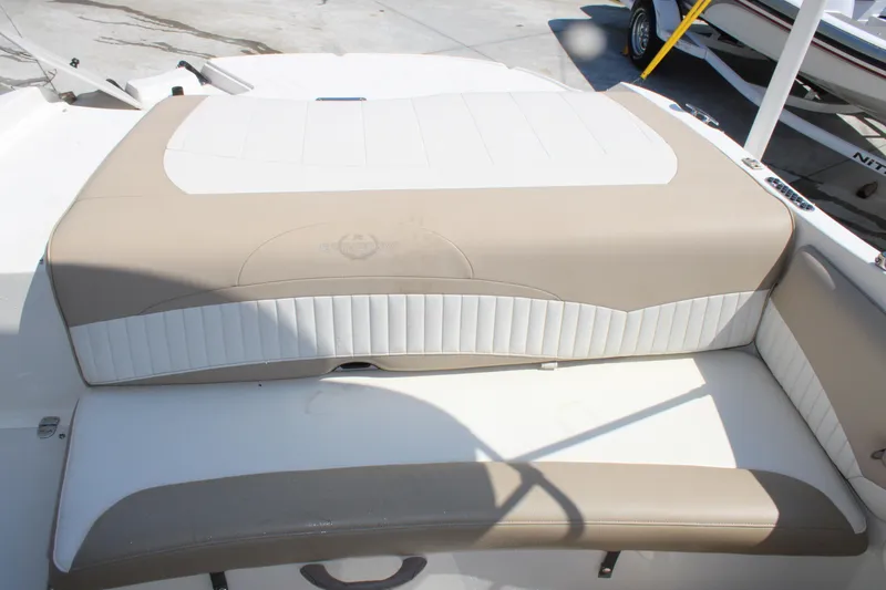 Slide: The Image of 2014 Stingray 198 LF boat interior seating with beige and white upholstery. - 19