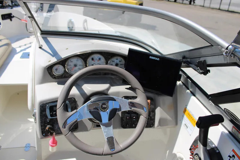 Slide: The Image of 2014 Stingray 198 LF boat dashboard with steering wheel and navigation system. - 20