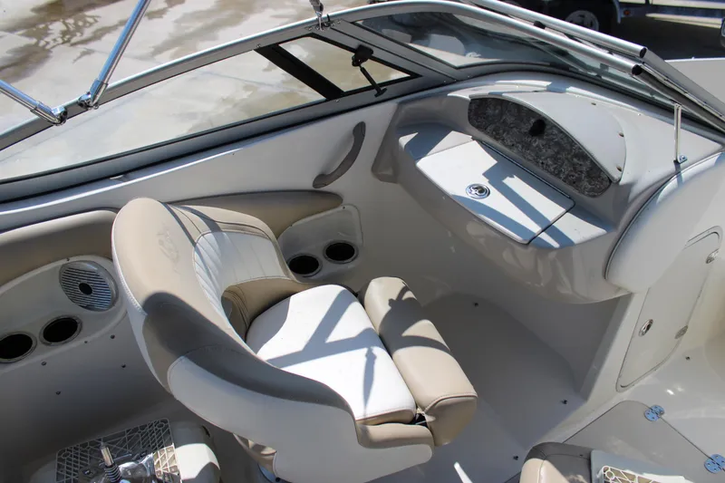 Slide: The Image of 2014 Stingray 198 LF boat interior with beige seating and dashboard. - 22