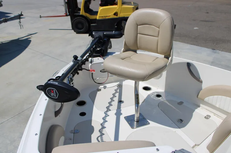 Slide: The Image of 2014 Stingray 198 LF boat with beige swivel seat and trolling motor. - 28