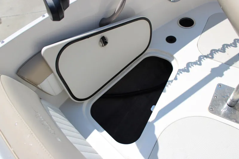 Slide: The Image of 2014 Stingray 198 LF boat interior storage compartment with open hatch and seating. - 29