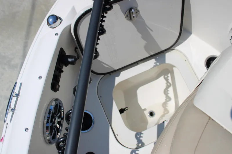 Slide: The Image of Interior view of a 2014 Stingray 198 LF boat, featuring storage and control panel. - 30