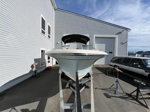 Slide: The Image of 2022 Grady-White Freedom 215 boat on a trailer outside a building. - 5