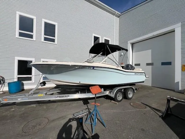 Slide: The Image of 2022 Grady-White Freedom 215 boat on a trailer outside a building. - 6