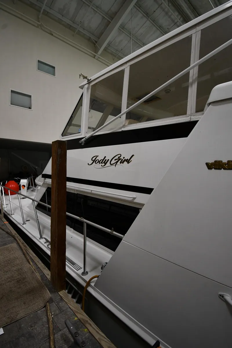 Slide: The Image of 1997 Viking 60 Cockpit Sport Yacht docked indoors. - 13