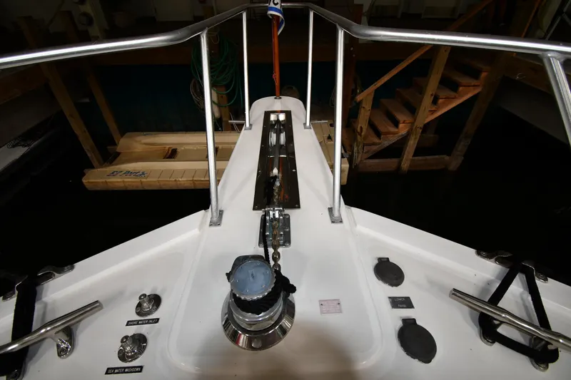 Slide: The Image of Bow deck of 1997 Viking 60 Cockpit Sport Yacht in a marina. - 15
