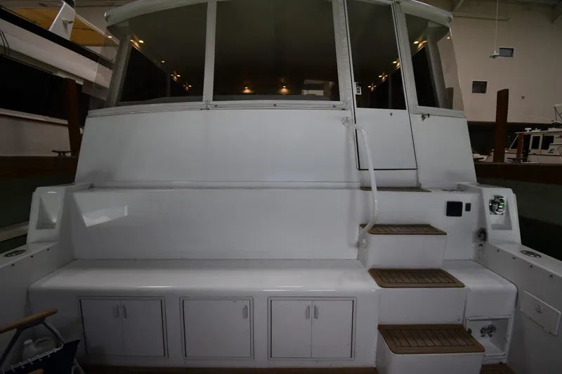 Slide: The Image of 1997 Viking 60 Cockpit Sport Yacht rear view with seating and steps. - 17