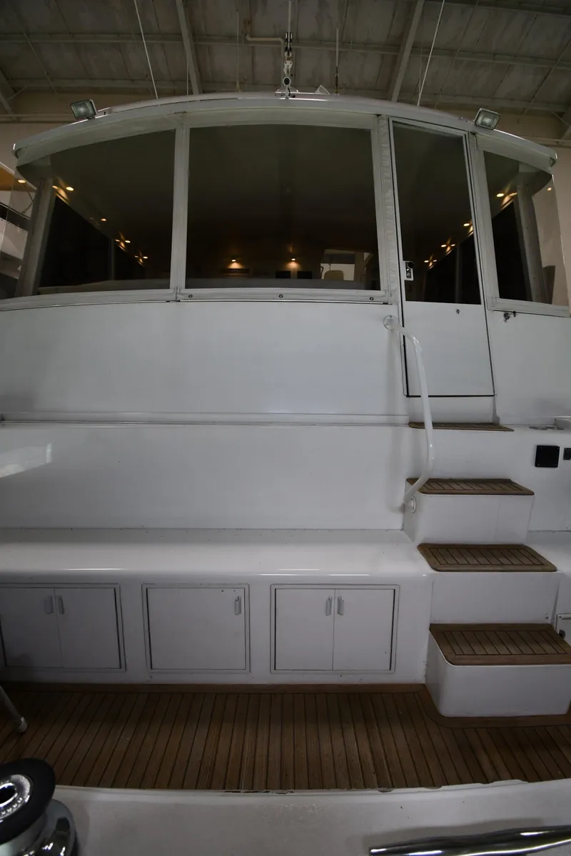 Slide: The Image of 1997 Viking 60 Cockpit Sport Yacht rear view with steps and storage compartments. - 18