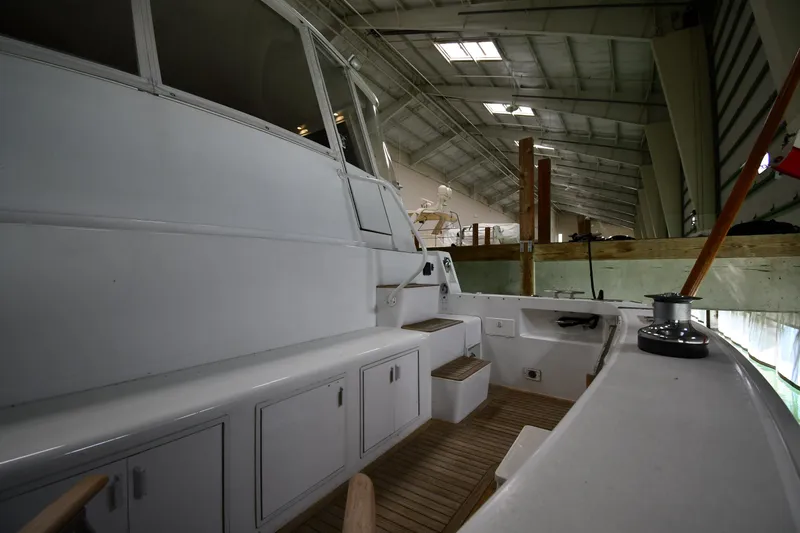 Slide: The Image of 1997 Viking 60 Cockpit Sport Yacht interior view in a boat storage facility. - 19