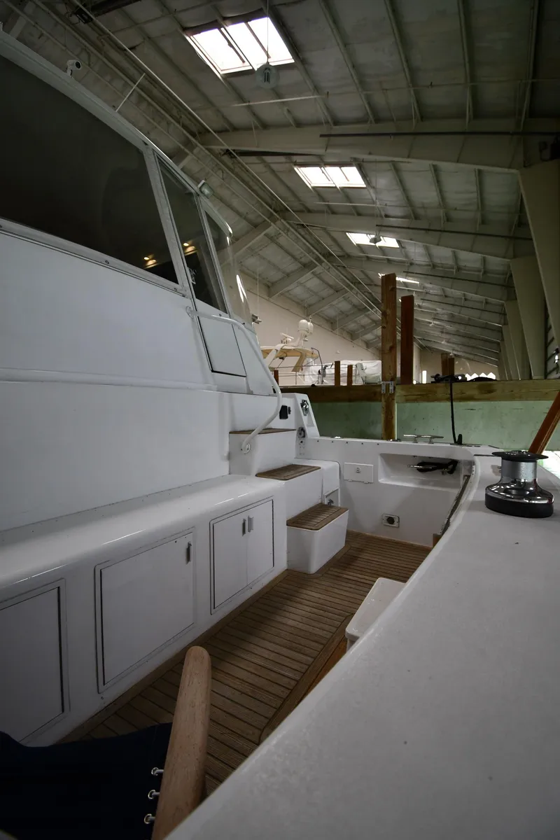 Slide: The Image of 1997 Viking 60 Cockpit Sport Yacht interior view in a boat storage facility. - 20