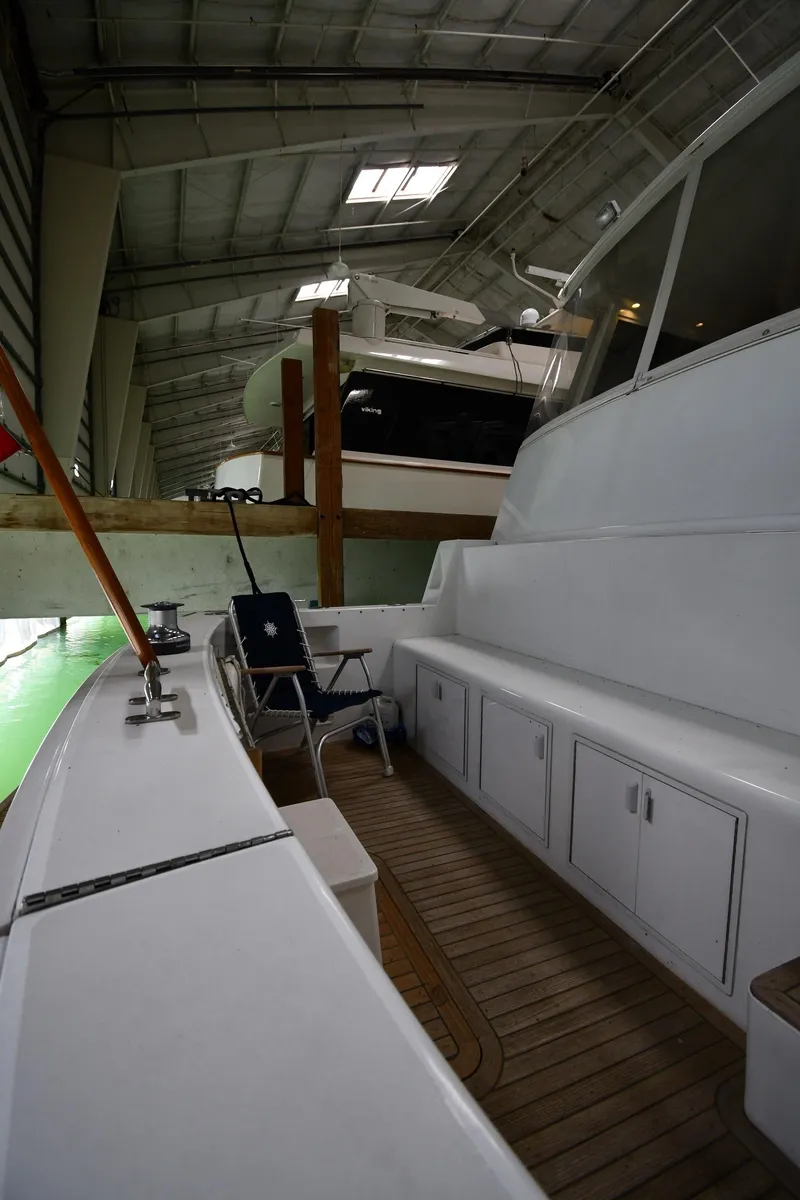 Slide: The Image of 1997 Viking 60 Cockpit Sport Yacht in a boat storage facility. - 22