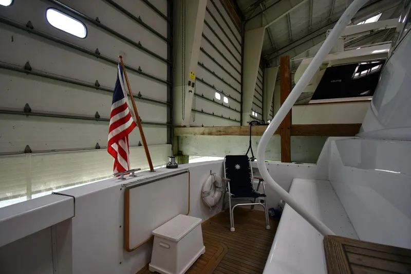 Slide: The Image of 1997 Viking 60 Cockpit Sport Yacht interior with American flag in storage. - 23