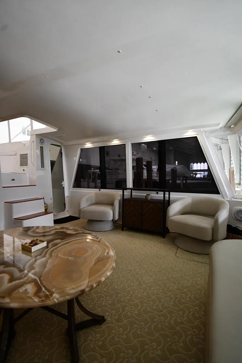Slide: The Image of Luxurious interior of a 1997 Viking 60 Cockpit Sport Yacht with modern furnishings. - 25