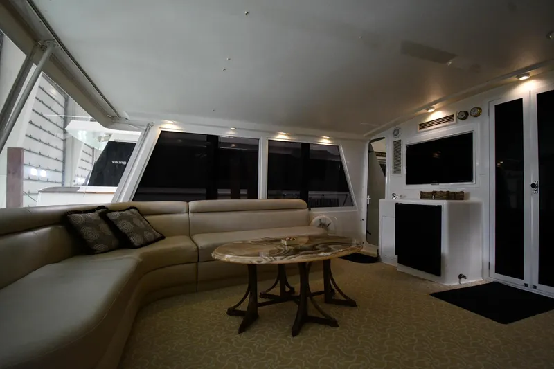 Slide: The Image of Luxurious interior of 1997 Viking 60 Cockpit Sport Yacht with plush seating and elegant table. - 26