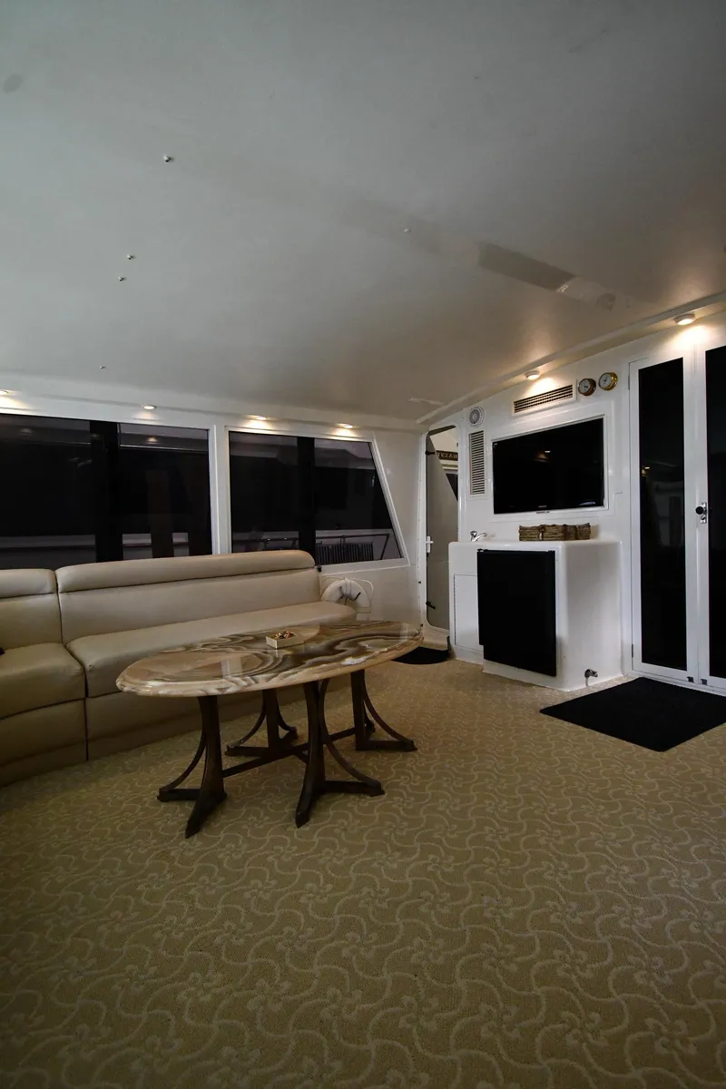 Slide: The Image of Luxurious interior of a 1997 Viking 60 Cockpit Sport Yacht with elegant seating and table. - 27