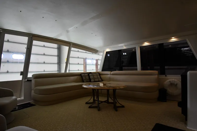 Slide: The Image of Interior of 1997 Viking 60 Cockpit Sport Yacht with beige seating and large windows. - 28
