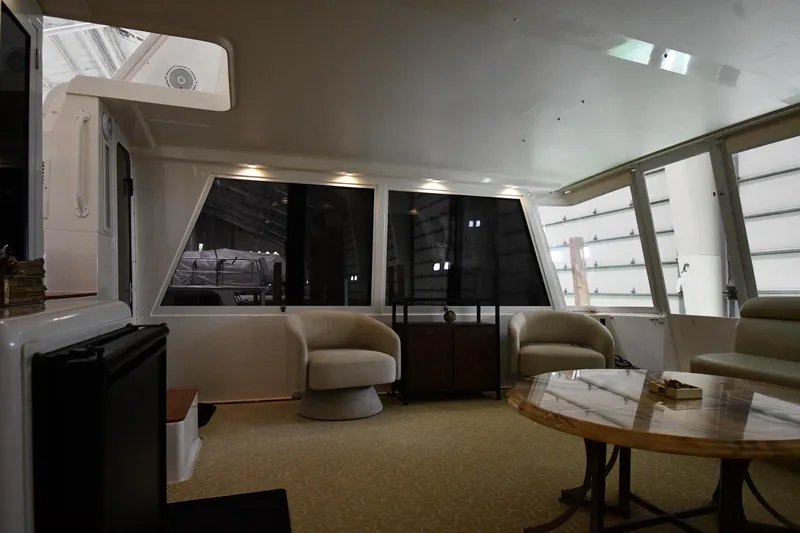 Slide: The Image of Interior of 1997 Viking 60 Cockpit Sport Yacht with modern seating and large windows. - 29
