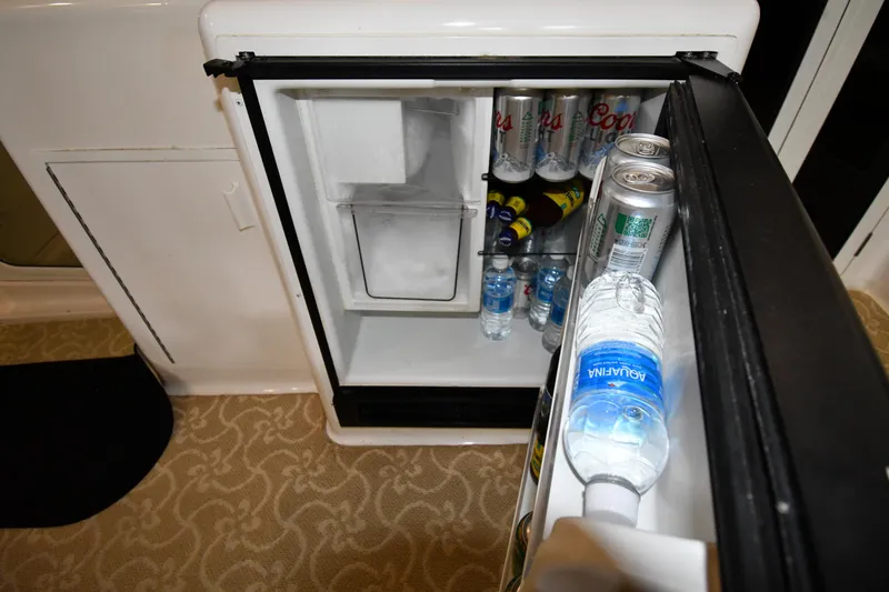 Slide: The Image of Mini fridge stocked with drinks on a 1997 Viking 60 Cockpit Sport Yacht. - 32