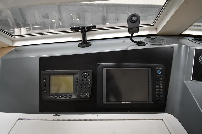 Slide: The Image of Control panel of a 1997 Viking 60 Cockpit Sport Yacht with navigation equipment. - 39