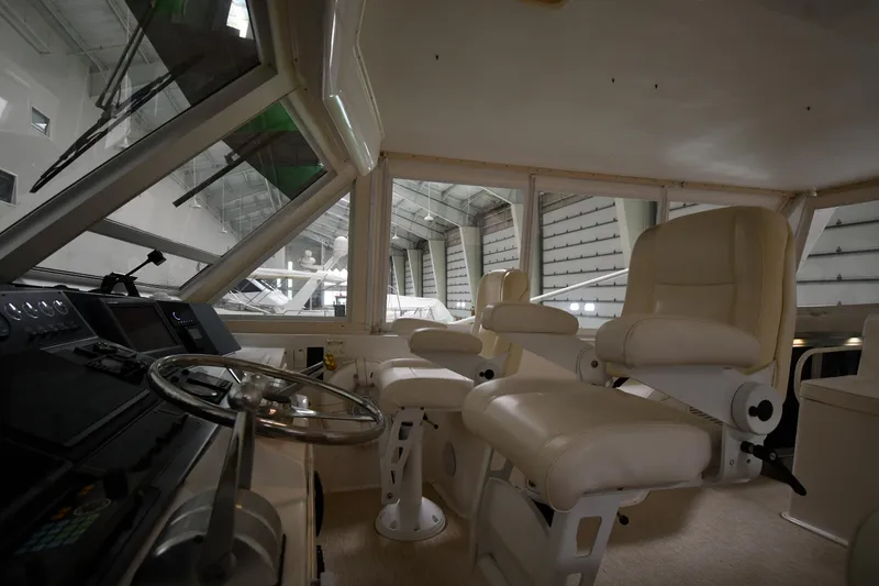 Slide: The Image of Interior cockpit of a 1997 Viking 60 Cockpit Sport Yacht with white leather seats. - 40