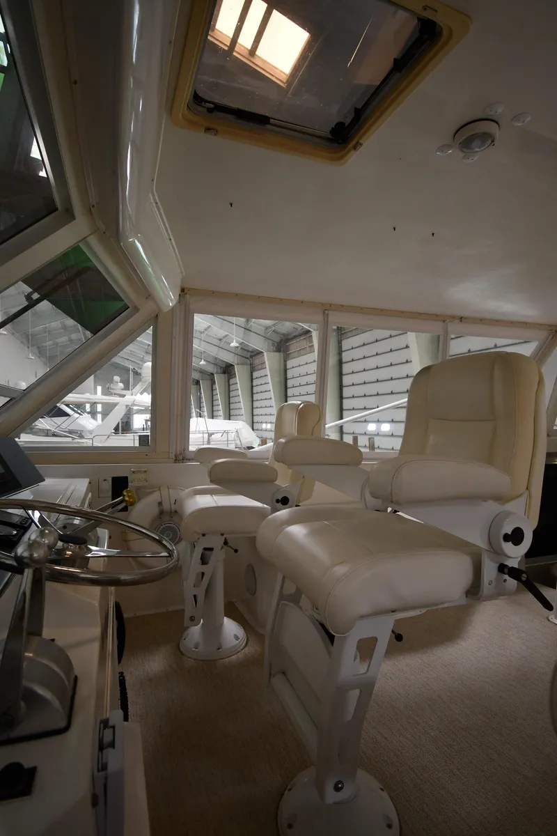 Slide: The Image of Interior cockpit of a 1997 Viking 60 Cockpit Sport Yacht with white leather seats. - 41