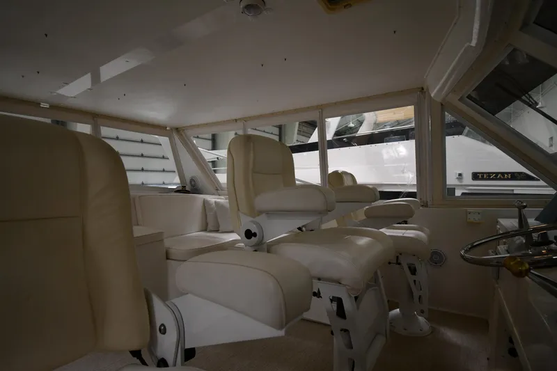 Slide: The Image of Interior of 1997 Viking 60 Cockpit Sport Yacht with cream leather seating. - 42