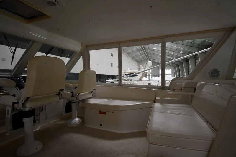 Slide: The Image of Interior of 1997 Viking 60 Cockpit Sport Yacht with seating and helm chairs. - 43