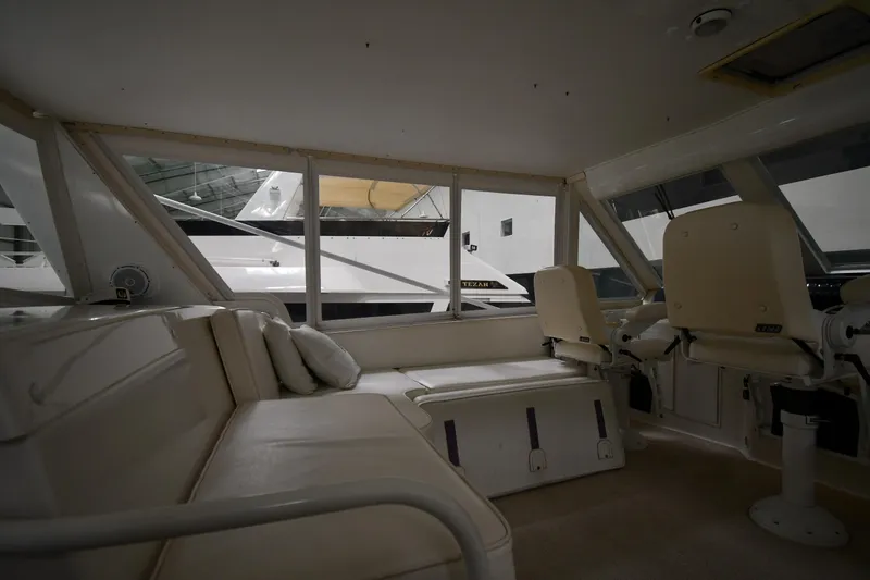 Slide: The Image of Interior of 1997 Viking 60 Cockpit Sport Yacht with seating and helm chairs. - 44