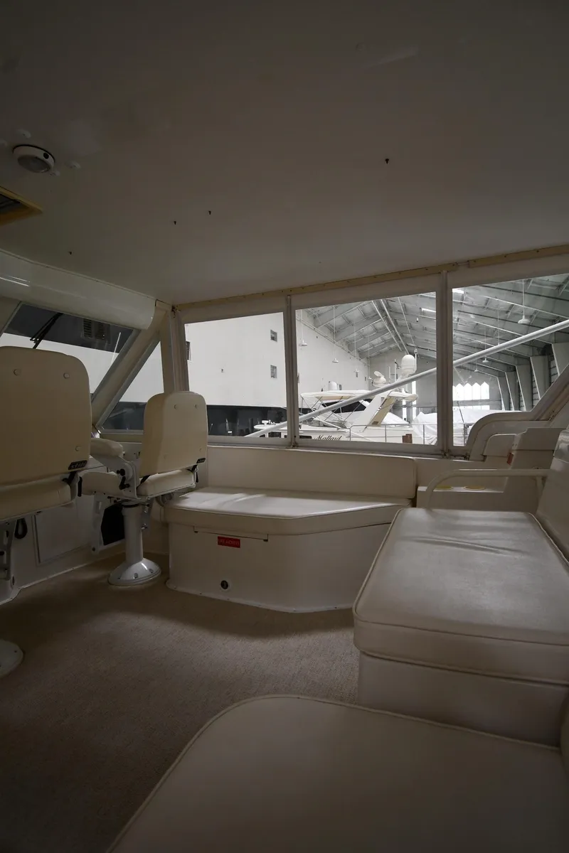 Slide: The Image of Interior of 1997 Viking 60 Cockpit Sport Yacht with spacious seating and large windows. - 48
