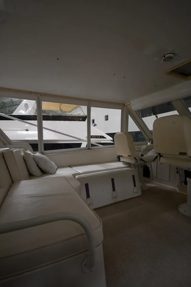 Slide: The Image of 1997 Viking 60 Cockpit Sport Yacht interior with seating and windows. - 49